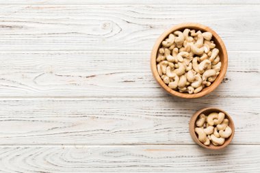 cashew nuts in wooden bowl on table background. top view. Space for text. Healthy food