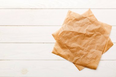 top view with baking parchment empty on table background. Folded cloth for mockup with copy space, Flat lay. Minimal style.