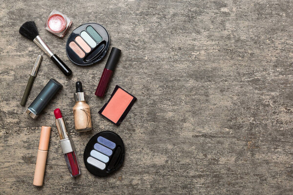 Professional makeup tools. Top view. Flat lay. Beauty, decorative cosmetics. Makeup brushes set and color eyeshadow palette on table background. Minimalistic style.