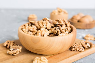 Fresh healthy walnuts in bowl on colored table background. Top view Healthy eating bertholletia concept. Super foods.