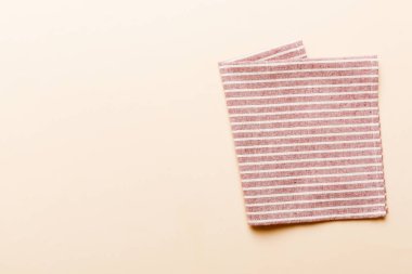 top view with red empty kitchen napkin isolated on table background. Folded cloth for mockup with copy space, Flat lay. Minimal style.