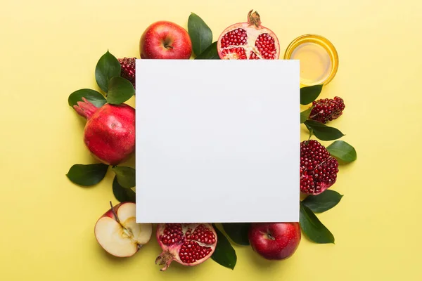 stock image Flat lay composition with Blank flyer poster and symbols jewish Rosh Hashanah holiday attributes on colored background, New Year holiday Traditional. Top view with copy space mock up.