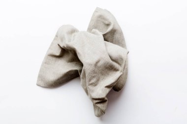 top view with gray kitchen napkin isolated on table background. Folded cloth for mockup with copy space, Flat lay. Minimal style.