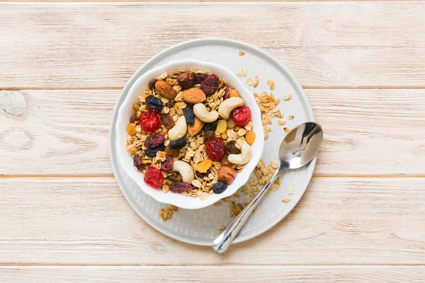 stock image Cooking a wholesome breakfast. Granola with Various dried fruits and nuts in a bowl. The concept of a healthy dessert. Flat lay, top view with copy space.