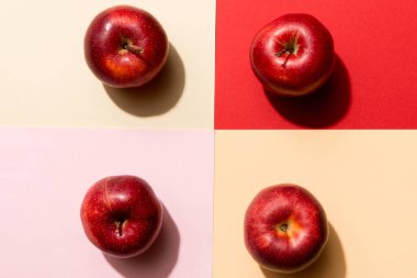 Renkli arka planda bir sürü kırmızı elma, üst manzara. Görüş üzerinde taze elma ile sonbahar deseni.