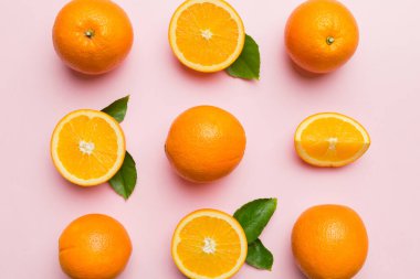 Renkli arka planda taze portakal dilimlerinin meyve deseni. Üst Manzara. Uzayı kopyala yaratıcı yaz konsepti. Minimum düzlükteki turunçgillerin yarısı.