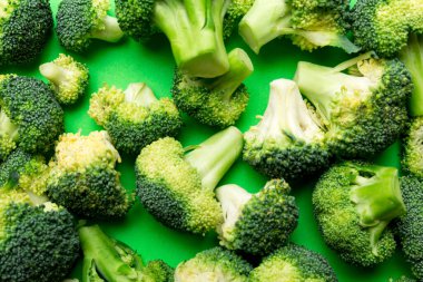 Renkli masaya yakın yeşil brokoli arkaplanı. Diyet ve sağlıklı yemek için sebzeler. Organik yiyecekler.