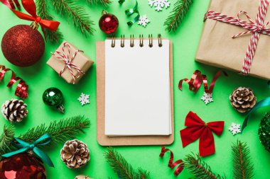 Christmas blank greeting card mock-up scene. Creative layout made of Christmas tree branches and paper card note. Flat lay. Nature New Year concept.