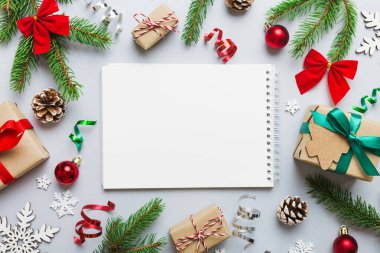 Christmas blank greeting card mock-up scene. Creative layout made of Christmas tree branches and paper card note. Flat lay. Nature New Year concept.