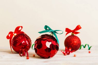 Christmas ball on colored background. decoration bauble with ribbon bow with copy space.