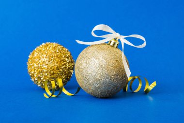 Christmas ball on colored background. decoration bauble with ribbon bow with copy space.