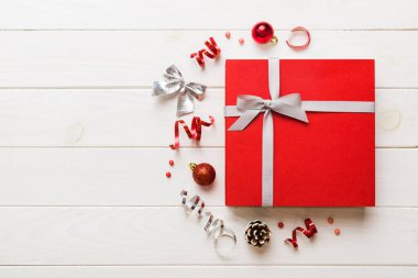 Top view Flat lay Christmas decorations and gift box on colored background with copy space. Christmas or Happy New Year composition.