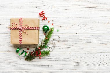 Top view Flat lay Christmas decorations and gift box on colored background with copy space. Christmas or Happy New Year composition.