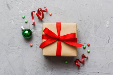 Top view Flat lay Christmas decorations and gift box on colored background with copy space. Christmas or Happy New Year composition.