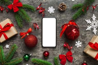 Digital phone mock up with rustic Christmas decorations for app presentation top view with empty space for you design. Christmas online shopping concept. Tablet with copy space on colored background.