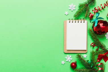 Christmas blank greeting card mock-up scene. Creative layout made of Christmas tree branches and paper card note. Flat lay. Nature New Year concept.