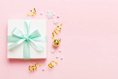 Top view Flat lay Christmas decorations and gift box on colored background with copy space. Christmas or Happy New Year composition.