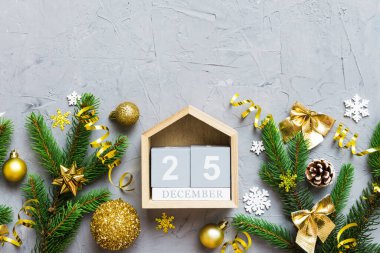 Christmas calendar 25 december. Christmas gift, fir branches, pine cones. Flat lay, top view. New Year decorations on a colored background.