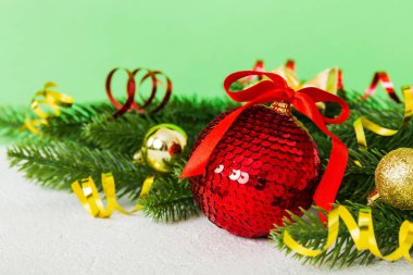New Year Christmas tree toy, branches of a christmas tree, New Year decorations on a colored background.