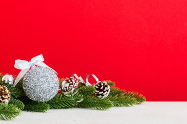 New Year Christmas tree toy, branches of a christmas tree, New Year decorations on a colored background.