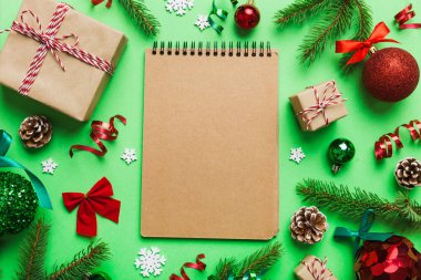 Christmas blank greeting card mock-up scene. Creative layout made of Christmas tree branches and paper card note. Flat lay. Nature New Year concept.