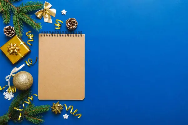 Christmas blank greeting card mock-up scene. Creative layout made of Christmas tree branches and paper card note. Flat lay. Nature New Year concept.