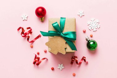 Top view Flat lay Christmas decorations and gift box on colored background with copy space. Christmas or Happy New Year composition.