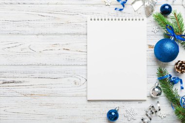 Christmas blank greeting card mock-up scene. Creative layout made of Christmas tree branches and paper card note. Flat lay. Nature New Year concept.