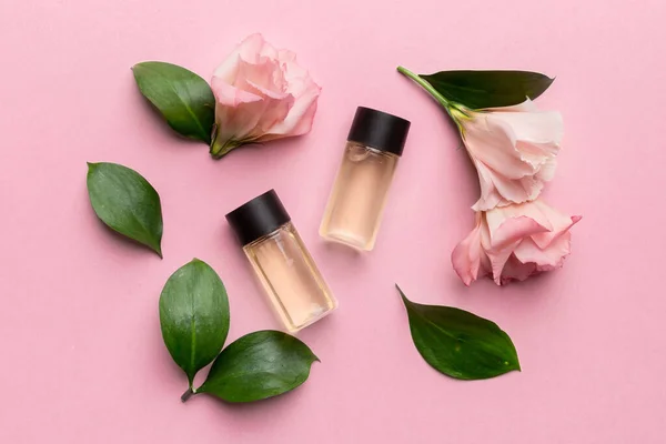 Composition with cosmetic products and beautiful roses on color background. Flat lay.