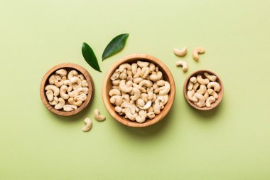 cashew nuts in wooden bowl on table background. top view. Space for text. Healthy food