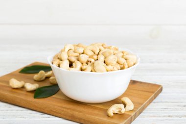 cashew nuts in wooden bowl on table background. top view. Space for text. Healthy food
