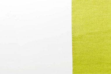 top view with green kitchen napkin isolated on table background. Folded cloth for mockup with copy space, Flat lay. Minimal style.