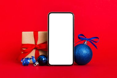 Digital phone mock up with rustic Christmas decorations for app presentation with empty space for you design. Christmas online shopping concept. Tablet with copy space on colored background.