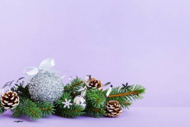 New Year Christmas tree toy, branches of a christmas tree, New Year decorations on a colored background.