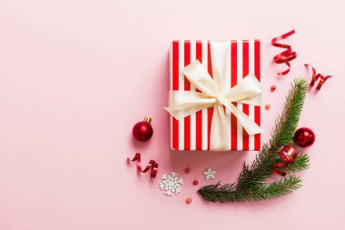 Top view Flat lay Christmas decorations and gift box on colored background with copy space. Christmas or Happy New Year composition.