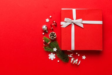 Top view Flat lay Christmas decorations and gift box on colored background with copy space. Christmas or Happy New Year composition.
