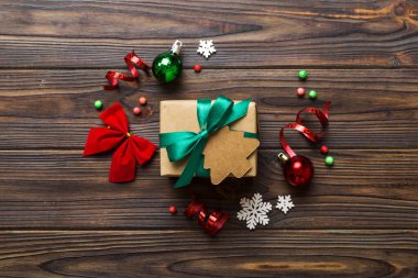 Top view Flat lay Christmas decorations and gift box on colored background with copy space. Christmas or Happy New Year composition.