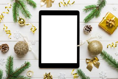 Digital tablet mock up with rustic Christmas decorations for app presentation top view with empty space for you design. Christmas online shopping concept. Tablet with copy space on colored background.