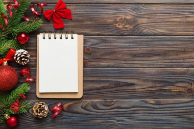 Christmas blank greeting card mock-up scene. Creative layout made of Christmas tree branches and paper card note. Flat lay. Nature New Year concept.