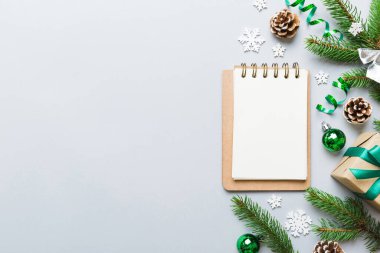 Christmas blank greeting card mock-up scene. Creative layout made of Christmas tree branches and paper card note. Flat lay. Nature New Year concept.