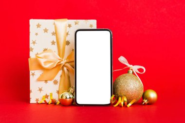 Digital phone mock up with rustic Christmas decorations for app presentation with empty space for you design. Christmas online shopping concept. Tablet with copy space on colored background.