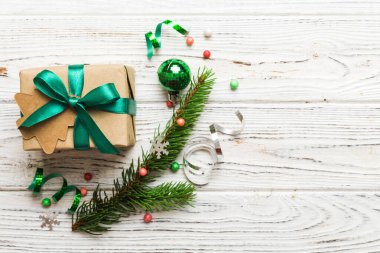 Top view Flat lay Christmas decorations and gift box on colored background with copy space. Christmas or Happy New Year composition.