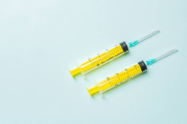 Renkli arka planda fotokopi alanı olan tıbbi şırıngaların üst görüntüsü. Enjeksiyon ekipmanı konsepti.