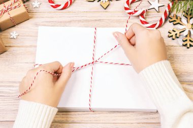 Kadınlar Noel mektuplarını zarfa bağlar, Noel Baba mektuplarını zarfa koyar, Noel arkaplanı olur. Ayarlanmış.