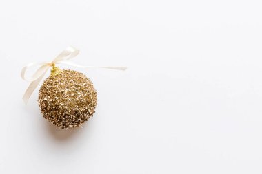 Christmas ball on colored background. decoration bauble with ribbon bow with copy space.