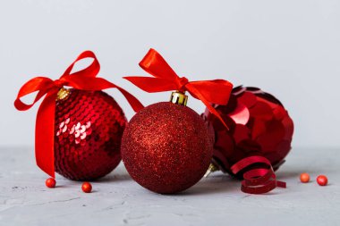 Christmas ball on colored background. decoration bauble with ribbon bow with copy space.