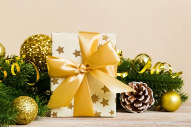 New Year Christmas mood, gift box, branches of a christmas tree, New Year decorations on a colored background.