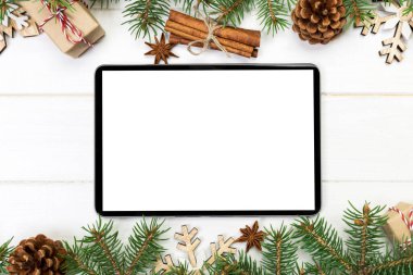 Dijital tablet kadar app tanıtımı için rustik Noel ahşap arka plan süslemeleri ile alay. kopya alanı ile üstten görünüm.