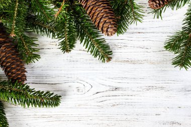 Ahşap arka plan üzerinde koniler ile Noel ağacı dalları.