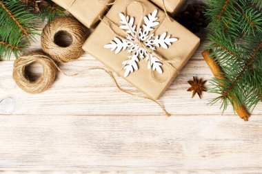 Noel dekorasyon öğeleri: dize chrtistmas ağaç dallarının koniler ile birkaç dekore edilmiş ve Beyaz ahşap zemin üzerinde hediyeler.